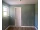Bedroom featuring wood laminate flooring and a large window at 5832 Michelle Ln, Sanford, FL 32771