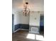 Bright dining area featuring a modern globe chandelier and light wood flooring at 5832 Michelle Ln, Sanford, FL 32771