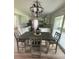 Well-lit dining area featuring a dark wood table with grey chairs adjacent to the kitchen at 5832 Michelle Ln, Sanford, FL 32771