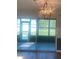 Dining area featuring a modern chandelier, patio access, and sunroom views at 5832 Michelle Ln, Sanford, FL 32771