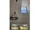 Bright entryway with high ceilings, modern light fixture, and large windows overlooking the scenic yard at 5832 Michelle Ln, Sanford, FL 32771