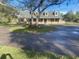 Charming single-Gathering home featuring dormer windows, a well-manicured lawn and mature trees at 5832 Michelle Ln, Sanford, FL 32771
