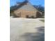 A brick house featuring an outdoor space with A/C units and a concrete slab for parking at 5832 Michelle Ln, Sanford, FL 32771