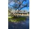 Charming single-Gathering home featuring dormer windows, a well-manicured lawn and mature trees at 5832 Michelle Ln, Sanford, FL 32771