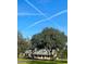 Charming two-story home with mature trees and well-maintained front yard with a long, winding driveway at 5832 Michelle Ln, Sanford, FL 32771