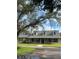 Charming one-story home with light brick, mature trees, black shutters, and inviting curb appeal at 5832 Michelle Ln, Sanford, FL 32771