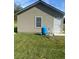 Side exterior view of home featuring a blue water tank in the lawn at 5832 Michelle Ln, Sanford, FL 32771