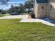 Brick home with a circular driveway, lush lawn and a parked car at 5832 Michelle Ln, Sanford, FL 32771