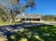 Beautiful home showcasing a circular driveway, mature trees, and lush front lawn at 5832 Michelle Ln, Sanford, FL 32771