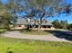 Attractive home featuring dormer windows, a circular driveway, and mature landscaping at 5832 Michelle Ln, Sanford, FL 32771