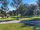 Well-maintained front yard with lush grass and trees, complementing the property's curb appeal at 5832 Michelle Ln, Sanford, FL 32771
