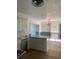 Kitchen with stainless appliances, an island, white cabinets and an open dining room space at 5832 Michelle Ln, Sanford, FL 32771
