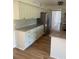 Bright kitchen with stainless steel refrigerator, white cabinets, granite counters and breakfast bar at 5832 Michelle Ln, Sanford, FL 32771