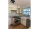 Kitchen featuring granite counters, gas range, white cabinets, stainless appliances and open shelving at 5832 Michelle Ln, Sanford, FL 32771