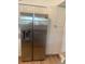 Bright kitchen with stainless steel refrigerator, white cabinets, granite counters and pantry at 5832 Michelle Ln, Sanford, FL 32771