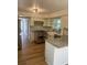 Bright kitchen with stainless steel appliances, custom cabinets, a farmhouse sink, and granite countertops at 5832 Michelle Ln, Sanford, FL 32771