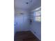 Laundry room featuring wood laminate flooring, floating shelves and neutral paint at 5832 Michelle Ln, Sanford, FL 32771