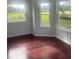 Living room featuring hardwood floors and large windows for natural light at 5832 Michelle Ln, Sanford, FL 32771