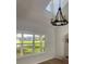 Vaulted ceiling living room with a chandelier and large windows overlooking a pasture at 5832 Michelle Ln, Sanford, FL 32771