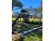 Backyard playground with a slide and swing set surrounded by mature trees at 5832 Michelle Ln, Sanford, FL 32771