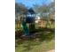 This is a playground set for children with a slide, swings, and wooden playhouse under a tree at 5832 Michelle Ln, Sanford, FL 32771