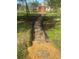 A detailed shot of the backyard area including a playhouse and playground with stone path at 5832 Michelle Ln, Sanford, FL 32771