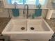A large, white farmhouse sink with dual basins and a modern faucet is the focal point at 5832 Michelle Ln, Sanford, FL 32771