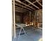 Unfinished basement showing exposed framing, ladder, and supplies ready for your vision at 585 Washington St, New Smyrna Beach, FL 32168