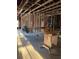Unfinished basement showing exposed framing and supplies ready for your vision at 585 Washington St, New Smyrna Beach, FL 32168