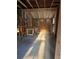 Unfinished basement with exposed framework, insulation, and ladder at 585 Washington St, New Smyrna Beach, FL 32168