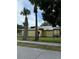 Charming single-story home with yellow siding, mature trees, and a quaint yard at 585 Washington St, New Smyrna Beach, FL 32168