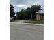 Exterior of a home with partial view, chain link fence, and mature landscaping at 585 Washington St, New Smyrna Beach, FL 32168