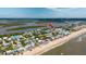 Wonderful aerial view of beach house and JB's Fishcamp near the coast, featuring sandy beach at 6883 S Atlantic Ave, New Smyrna Beach, FL 32169