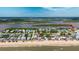 Beautiful aerial view highlights the beach house location, with a river in the background at 6883 S Atlantic Ave, New Smyrna Beach, FL 32169