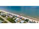 Panoramic aerial view of the beach house nestled along the ocean, close to the sandy beach at 6883 S Atlantic Ave, New Smyrna Beach, FL 32169