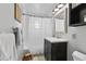 Clean bathroom featuring a shower with white curtain, a vanity, and a decorative wooden stool at 6883 S Atlantic Ave, New Smyrna Beach, FL 32169