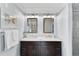 Modern bathroom features double sinks, framed mirrors, and stylish lighting at 6883 S Atlantic Ave, New Smyrna Beach, FL 32169