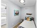 Small bedroom featuring a single bed, playful nautical artwork, and view into connecting room at 6883 S Atlantic Ave, New Smyrna Beach, FL 32169