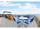 Spacious outdoor deck with seating and table offering stunning ocean views and beach access at 6883 S Atlantic Ave, New Smyrna Beach, FL 32169