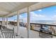 Spacious covered deck with ocean views, ideal for outdoor dining and relaxation with friends at 6883 S Atlantic Ave, New Smyrna Beach, FL 32169