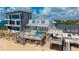 Beachfront home with a spacious deck featuring colorful seating and ocean views at 6883 S Atlantic Ave, New Smyrna Beach, FL 32169