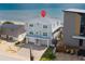 Coastal two-story home featuring a light grey exterior with beach access and a two-car garage at 6883 S Atlantic Ave, New Smyrna Beach, FL 32169