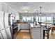 Modern eat-in kitchen with white cabinets, stainless steel appliances, and ocean views at 6883 S Atlantic Ave, New Smyrna Beach, FL 32169