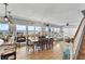 Bright living area boasts an ocean view, dining table and chairs, and hardwood floors at 6883 S Atlantic Ave, New Smyrna Beach, FL 32169
