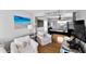 Bright living room leading to game room and featuring stylish decor and comfortable seating at 6883 S Atlantic Ave, New Smyrna Beach, FL 32169