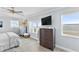 Charming main bedroom offering ocean views, a ceiling fan, and a TV at 6883 S Atlantic Ave, New Smyrna Beach, FL 32169