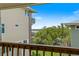 Balcony view featuring a waterfront scene filled with lush trees underneath a gorgeous blue sky at 6956 Turtlemound Rd, New Smyrna Beach, FL 32169
