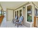 Covered balcony featuring cozy chairs with a small table and an outside storage closet at 6956 Turtlemound Rd, New Smyrna Beach, FL 32169
