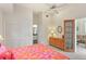 Bright bedroom featuring a comfy bed, closet space, dresser, and an ensuite at 6956 Turtlemound Rd, New Smyrna Beach, FL 32169