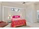 Bright bedroom featuring a comfy bed, fan, and ample closet space at 6956 Turtlemound Rd, New Smyrna Beach, FL 32169